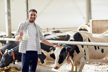 Image showing man or farmer with cows milk on dairy farm