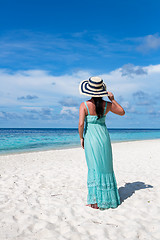 Image showing Girl walking along a tropical beach in the Maldives.