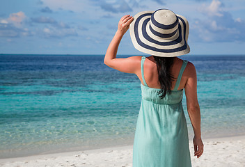 Image showing Girl walking along a tropical beach in the Maldives.