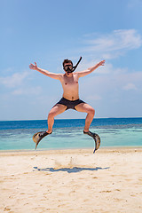 Image showing Funny man jumping in flippers and mask.