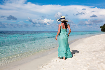 Image showing Girl walking along a tropical beach in the Maldives.