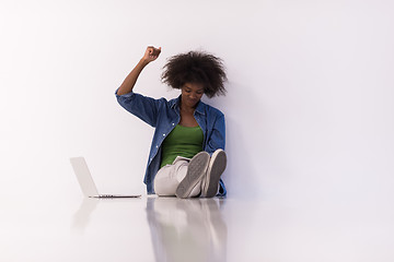 Image showing african american woman sitting on floor with laptop