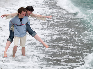 Image showing Young Couple Carrying Piggyback on Seashore