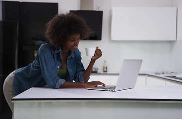 Image showing smiling black woman in modern kitchen