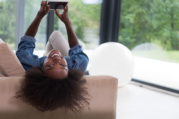 Image showing african american woman at home with digital tablet