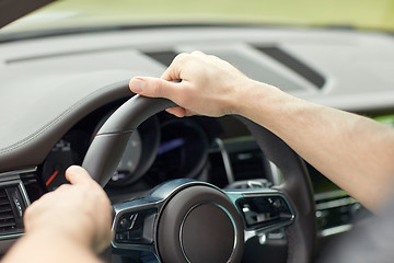 Image showing close up of male hands driving car