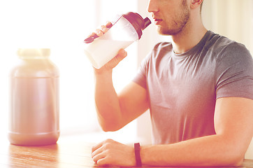 Image showing close up of man drinking protein shake