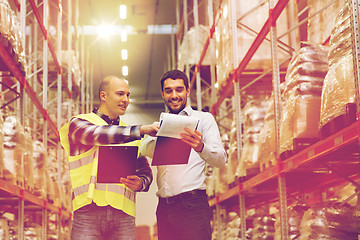 Image showing worker and businessmen with clipboard at warehouse