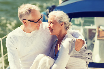 Image showing senior couple hugging on sail boat or yacht in sea