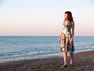 Image showing Young beautiful Lady Walks along Shore