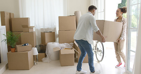 Image showing Happy young couple moving into a new house