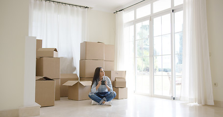 Image showing Young woman starting a new life in a new home