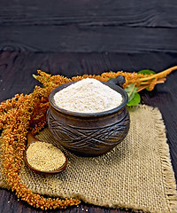 Image showing Flour amaranth in clay cup with flower on dark board