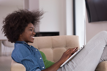 Image showing African American women at home in the chair using a laptop