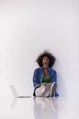 Image showing african american woman sitting on floor with laptop