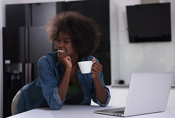 Image showing smiling black woman in modern kitchen