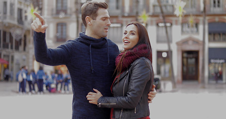 Image showing Attractive young man pointing out something