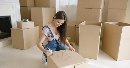 Image showing Pretty woman packing up her personal belongings