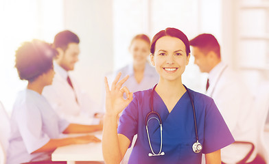 Image showing happy doctor over group of medics at hospital