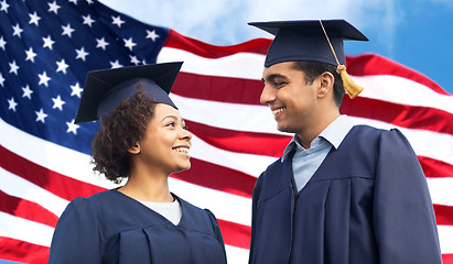 Image showing happy students or bachelors in mortar boards