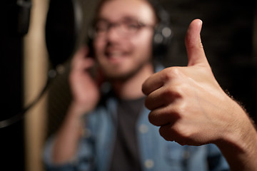 Image showing singer showing thumbs up at sound recording studio