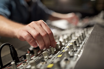 Image showing man using mixing console in music recording studio