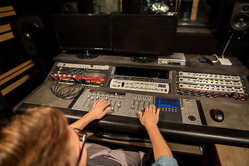 Image showing man at mixing console in music recording studio