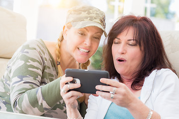 Image showing Two Female Friends Laugh While Using A Smart Phone