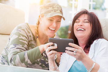 Image showing Two Female Friends Laugh While Using A Smart Phone