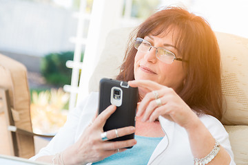 Image showing Attractive Middle Aged Woman Using Her Smart Phone