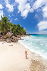 Image showing Woman enjoying Anse Patates picture perfect beach on La Digue Island, Seychelles.