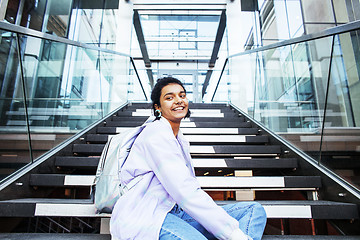 Image showing young cute indian girl at university building sitting on stairs 