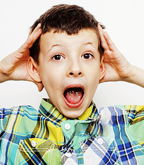 Image showing young pretty little cute boy kid wondering, posing emotional face isolated on white background, gesture happy smiling close up, lifestyle people concept