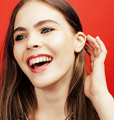 Image showing young pretty teenage woman emotional posing on pink background, fashion lifestyle people concept 