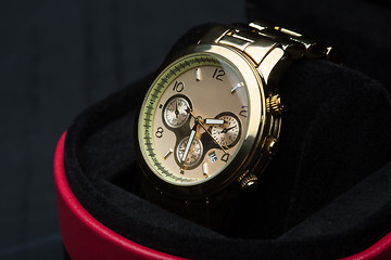 Image showing gold watch isolated on black background