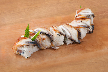 Image showing Japanese sushi with eel on wooden plate