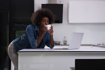 Image showing smiling black woman in modern kitchen