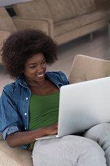 Image showing African American women at home in the chair using a laptop