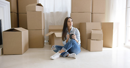 Image showing Young woman relaxing with a mug of coffee