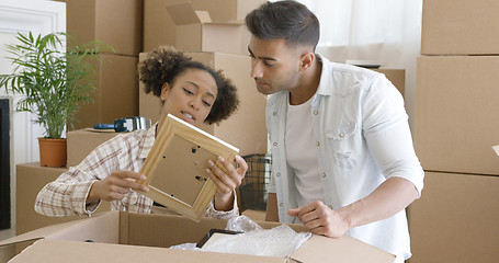 Image showing Attractive couple unpacking their things in new home