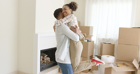 Image showing Joyful young couple celebrating their move