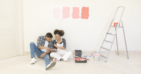 Image showing Young couple use tablet to discuss colors