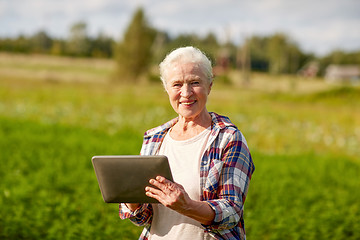 Image showing senior woman with tablet pc computer at county