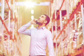 Image showing serious man calling on smartphone at warehouse