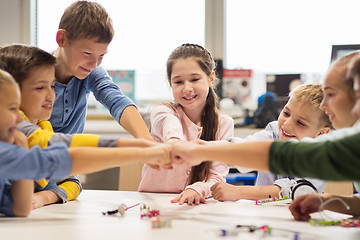 Image showing happy children making fist bump at robotics school