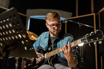 Image showing man playing guitar at studio rehearsal
