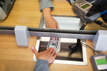 Image showing clerk giving cash money to customer at bank office