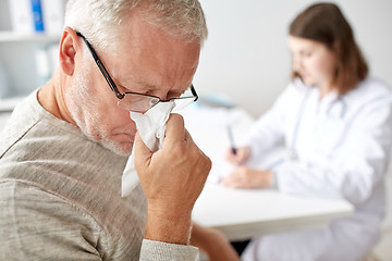 Image showing senior man blowing nose and doctor at hospital
