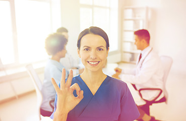 Image showing happy doctor over group of medics at hospital