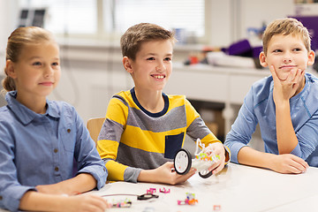 Image showing happy children building robots at robotics school